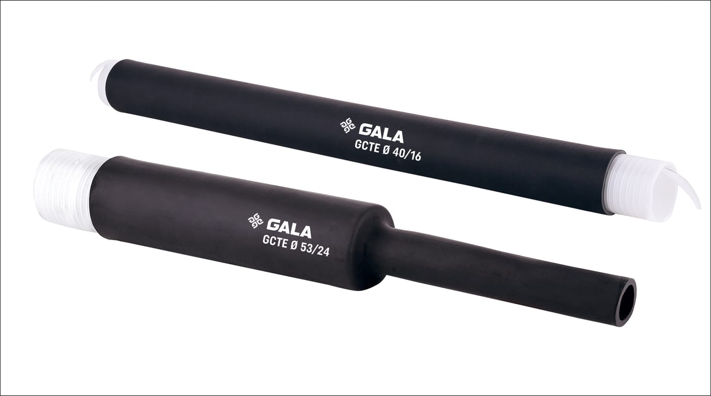 Two black cold shrink sleeves on white. The upper one is straight and full bore with a white spiral core showing at each end, printed GALA GCTE Ø 40/16. The lower one is printed GCTE Ø 53/24 and has already recovered down over its right-hand half to a narrow open tube.