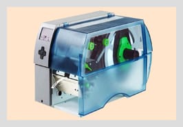 A benchtop thermal-transfer printer with a transparent blue lid and ribbon spools visible inside